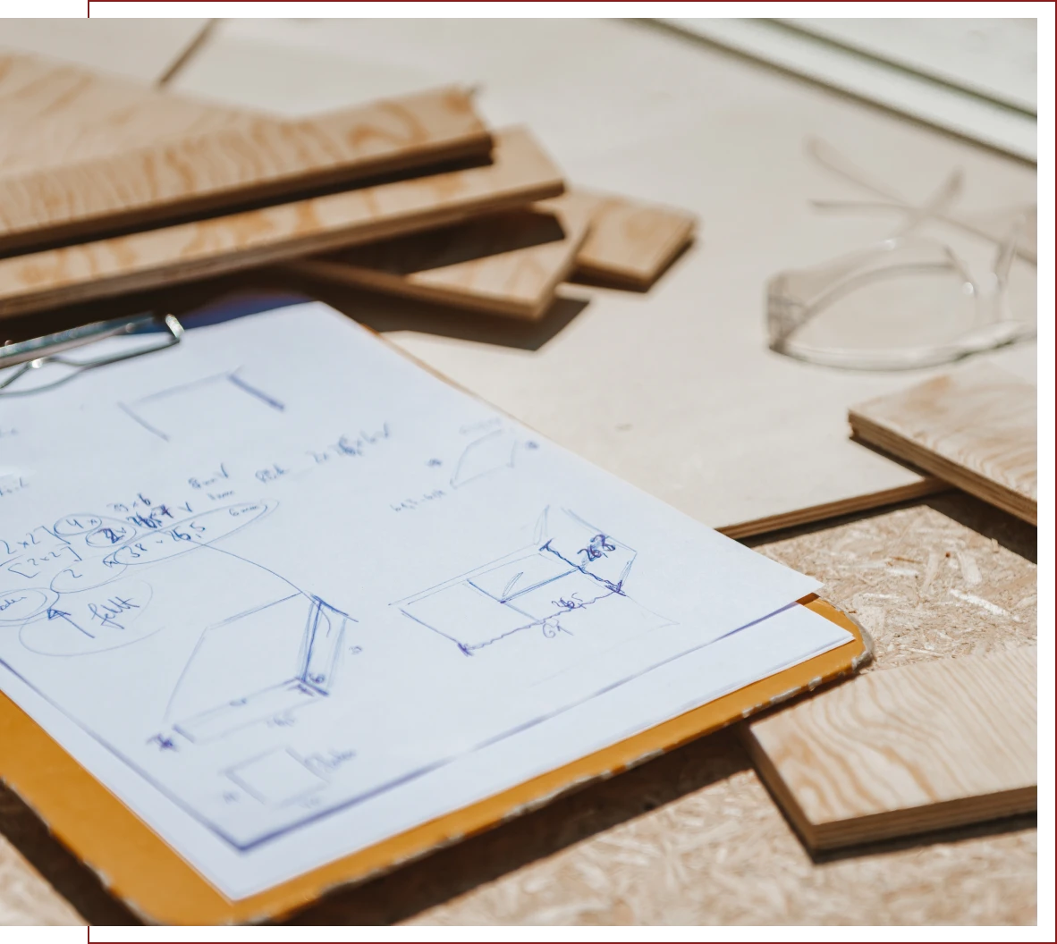 Blueprints and wood pieces on table